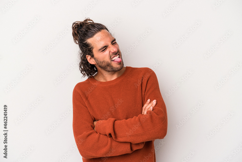 Young caucasian man isolated on gray background funny and friendly sticking out tongue. Young caucasian man isolated on gray background funny and friendly sticking out tongue.