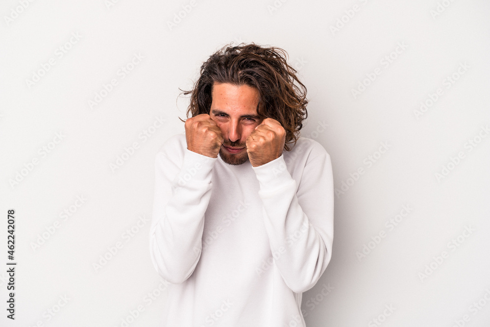 Young caucasian man isolated on gray background throwing a punch, anger, fighting due to an argument, boxing. Young caucasian man isolated on gray background throwing a punch, anger, fighting due to an argument, boxing.