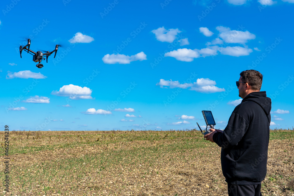 The pilot controls a professional drone The pilot controls a professional drone