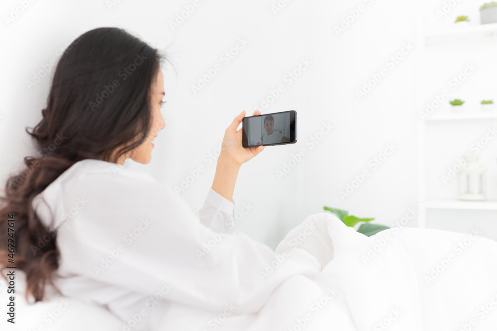 asian woman connect video call to her boyfriend with smartphone, she live video in bedroom, internet technology
