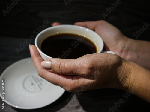 girl holding a coffee in her hands, coffee drink, cup of coffee, morning breakfast