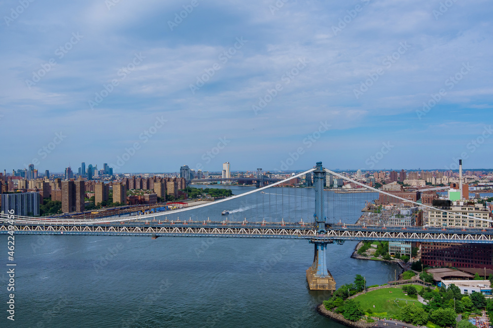 Aerial view of the Manhattan bridge through the East river to district in Skyline Manhattan America.
