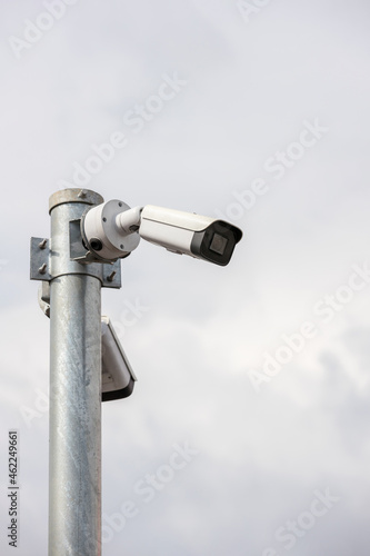 Online Security CCTV camera surveillance system outdoor of house. A blurred night city scape background. Real time Modern CCTV camera on a pole. Equipment system service for safety life or asset.