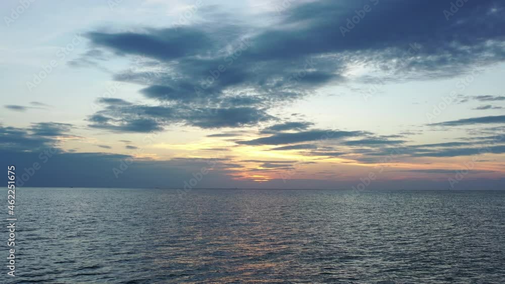 Aerial view drone flying above the ocean surface with golden reflections of sunset on sea water. Tropical Landscape of ocean and waves in evening. Relax. Nature and summer vacation concept. Aerial view drone flying above the ocean surface with golden reflections of sunset on sea water. Tropical Landscape of ocean and waves in evening. Relax. Nature and summer vacation concept.