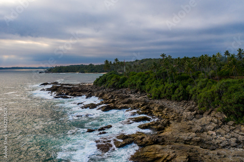 Aerial view of palm trees and Indian Oken coastline during sunset. Island Sri Lanka. photo