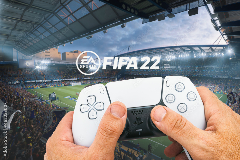 Male hand holding a Playstation 5 Dual Sense Controller with FIFA 22 game  blurred in the background. Rio de Janeiro, RJ, Brazil. October 2021. Stock  Photo | Adobe Stock