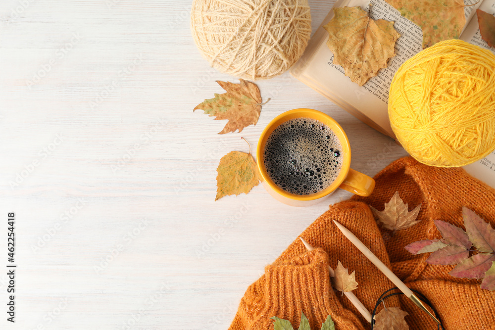 Concept of autumn with yarn balls on white wooden background Concept of autumn with yarn balls on white wooden background