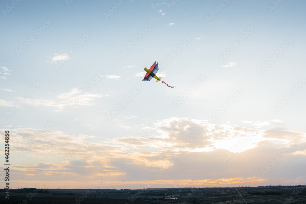 A beautiful kite soars against the blue sky. Freedom and space. A beautiful kite soars against the blue sky. Freedom and space.