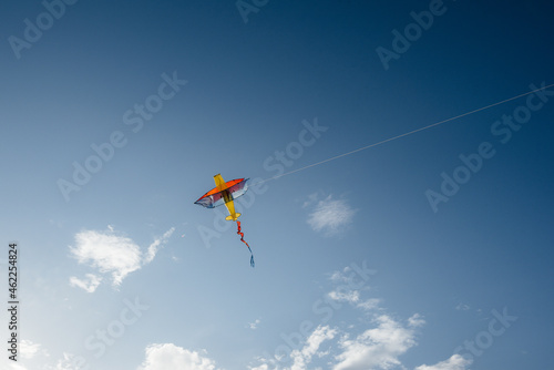 A beautiful kite soars against the blue sky. Freedom and space.