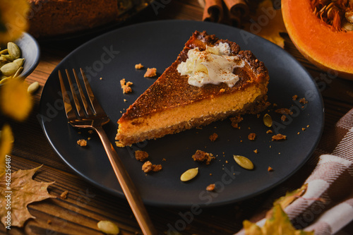 Homemade pumpkin cheesecake decorated with whipped cream.