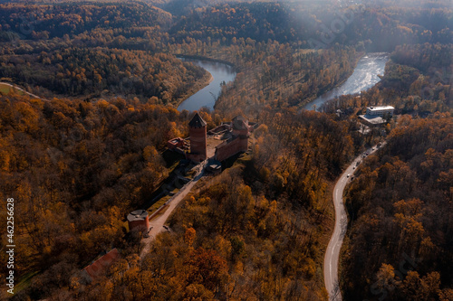 Aerial view of the Sigulda city in Latvia during golden autumn. Medieval castle in the middle of the forest.