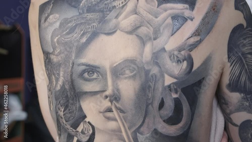 Video of man drawing tattoo on female back