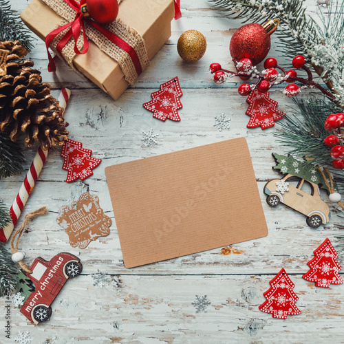 Christmas toys, gifts with a craft card for inserting text on a wooden background with snowflakes. copy space.