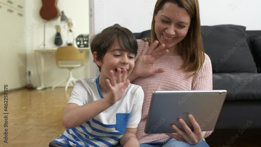 mother and child using digital tablet for video call, sitting in living room mother and child using digital tablet for video call, sitting in living room