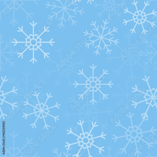 White snowflakes on blue background seamless pattern. Christmas seamless pattern of falling snowflakes in white grey colors with bokeh effect.