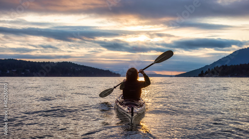 Adventurous Woman on Sea Kayak paddling in the Pacific Ocean. Summer Sunset Sky. Taken near Victoria, Vancouver Islands, British Columbia, Canada. Concept: Sport, Adventure © edb3_16