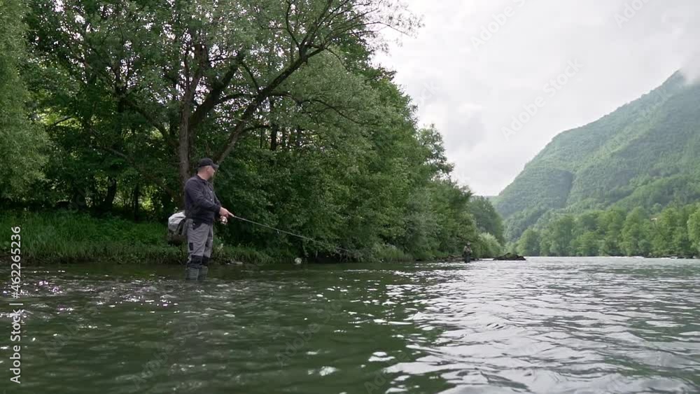 Angler fishing on a Lim, fast streaming water in Serbia Angler fishing on a Lim, fast streaming water in Serbia