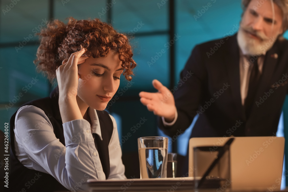 Tired businesswoman working in office at night Tired businesswoman working in office at night
