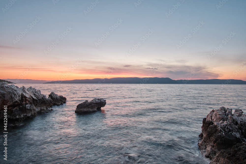 rock in adriatic sea during sunrise