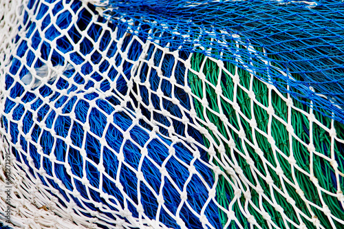 Green, white and blue coloured fishing nets