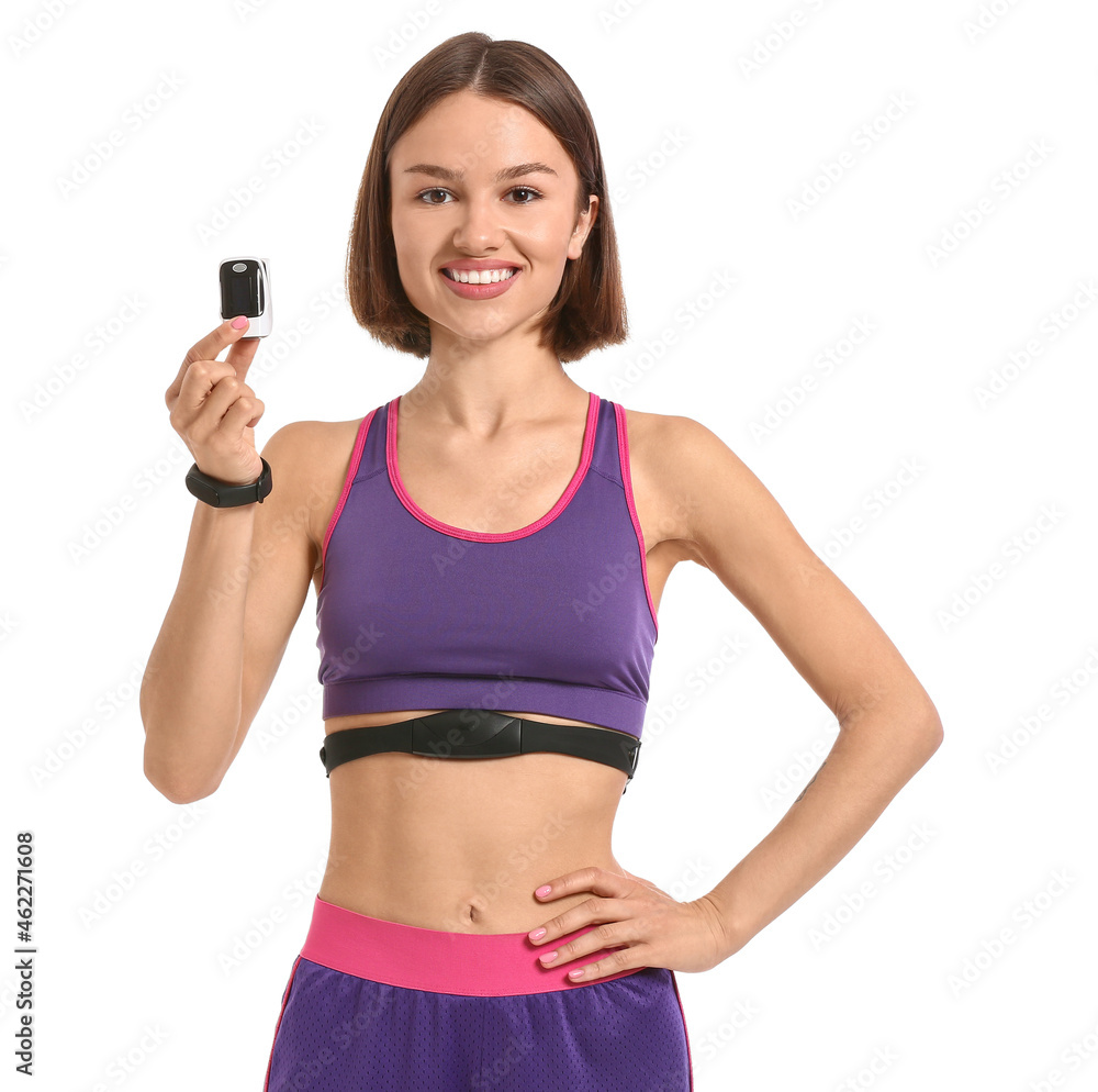 Sporty young woman with pulse oximeter on white background Sporty young woman with pulse oximeter on white background