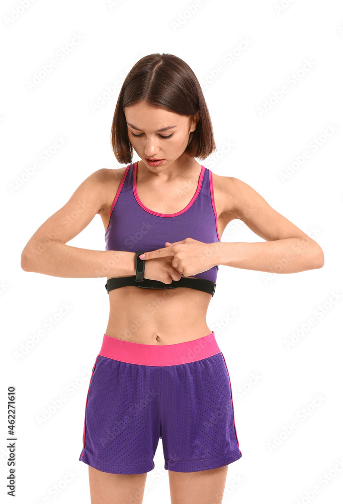 Sporty female runner checking pulse on white background Sporty female runner checking pulse on white background