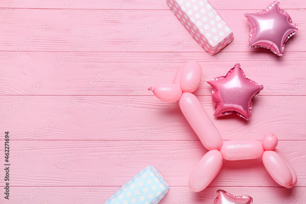 Gift boxes with dog shaped balloon on color wooden background Gift boxes with dog shaped balloon on color wooden background