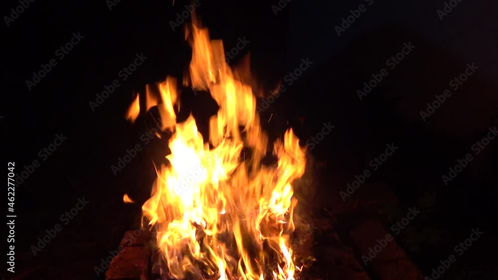 Flame, fire, embers at night. Dark background. Flame, fire, embers at night. Dark background.