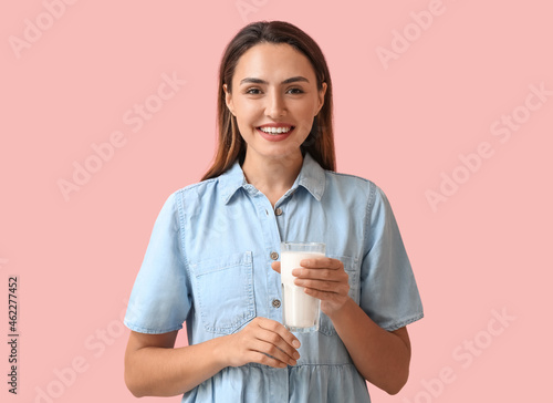 Smiling young woman holding...