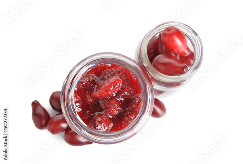 Jars of tasty dogwood jam and berries isolated on white background