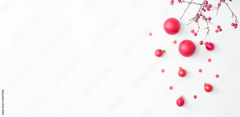 Flat lay frame with red berries, christmas red balls on a white background. Christmas and New Year banner with copy space for your text