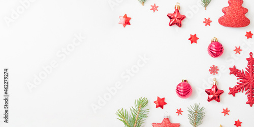 Flat lay frame with fir branches, christmas balls and decorations on a white background