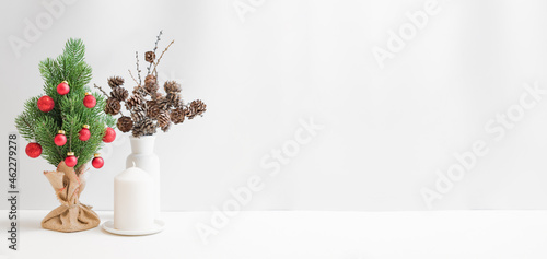 Christmas, New Year home decor. Christmas tree on a light background. Mock up for displaying works