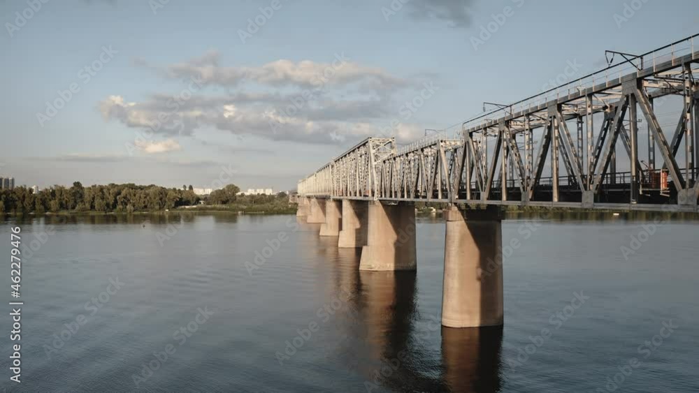 Railway bridge across the river. Logistics and transportation. Intercity railway connection by city electric train. Train metro bridge crossing river in city area. Railroad modern crossover. Aerial Railway bridge across the river. Logistics and transportation. Intercity railway connection by city electric train. Train metro bridge crossing river in city area. Railroad modern crossover. Aerial