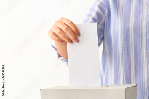 Voting woman near ballot box on white background