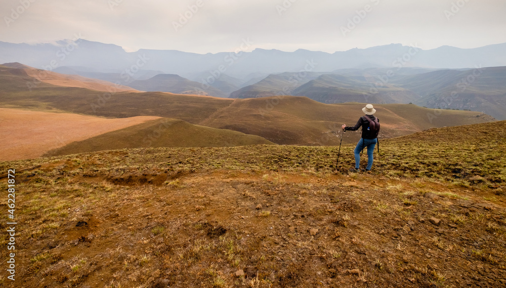 Lone female hiker near Giants Castle in the Drakensberg mountains, South Africa