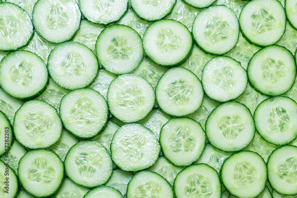 Fresh green slices of cucumber as background. Fresh green slices of cucumber as background.