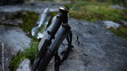 Wallpaper Mural hiking poles is near the rock during the rest in hiking trip. Walking sticks for active Hiking adventure on the mountains paths. Torontodigital.ca
