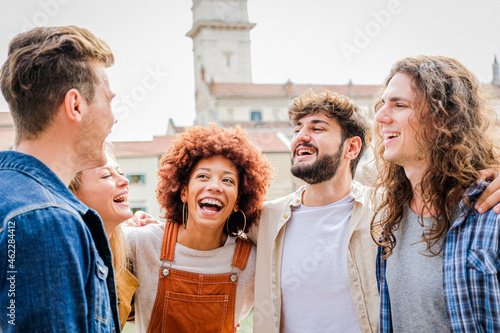 Friends laughing together - Multiracial guys having fun on the city street - Portrait of five students from different culture celebrating outside - Friendship, community, youth, university concept