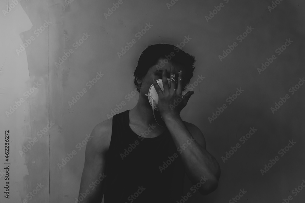 Man in mask doing paint works. spots of paint on the hand Man in mask doing paint works. spots of paint on the hand