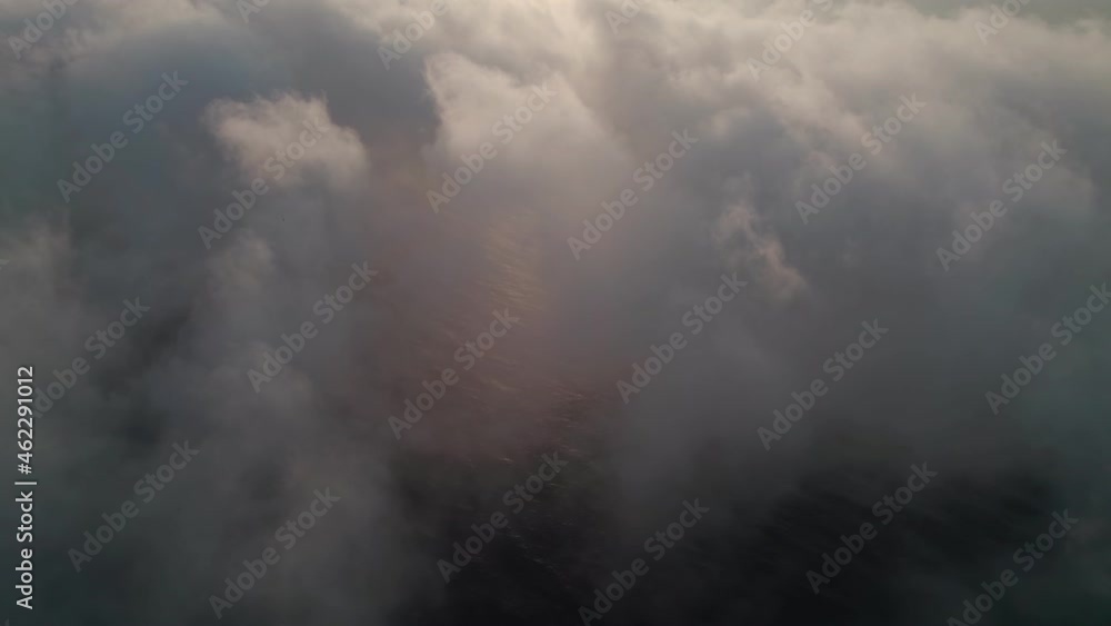 Fly through the clouds during sunrise. An epic shot of clouds in morning colors. Fly through the clouds during sunrise. An epic shot of clouds in morning colors.