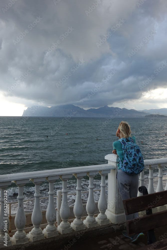 woman look at storm clouds over the sea