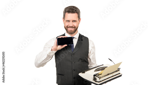 happy man hold retro typewriter and showing modern smartphone, copy space, presentation
