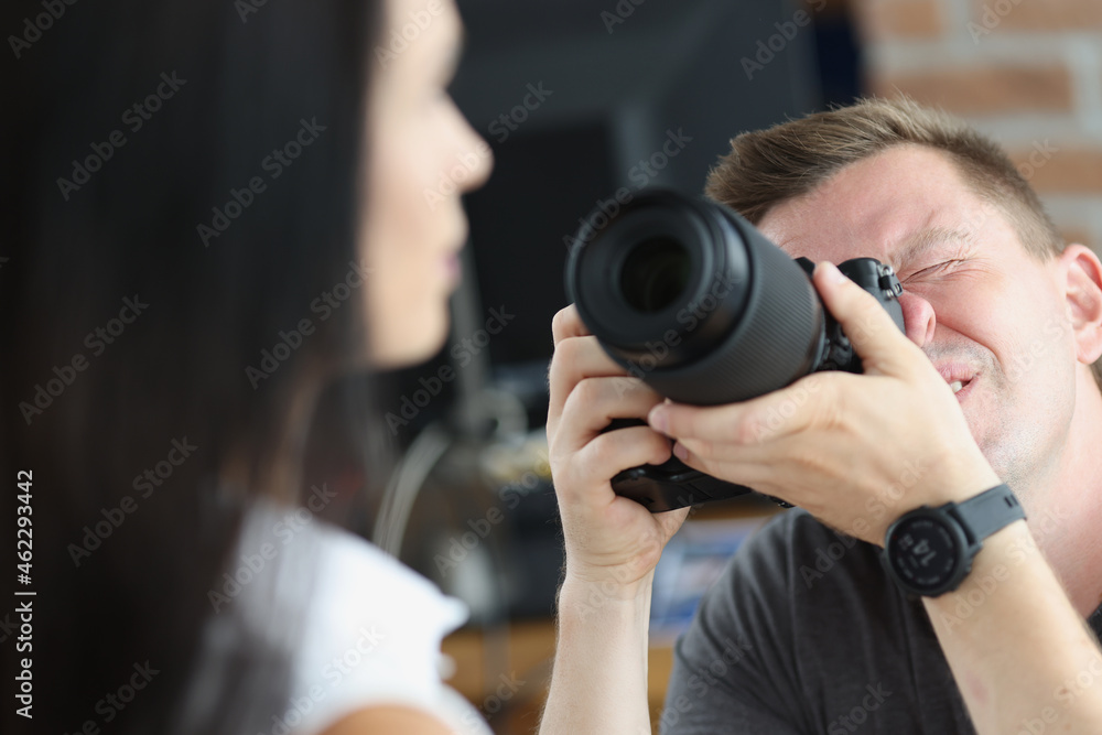 Man photographer is taking pictures of woman closeup