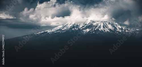 Moody landscape of famous Ararat mountain with fog clouds at the top. Symbol of Armenia and Yerevan