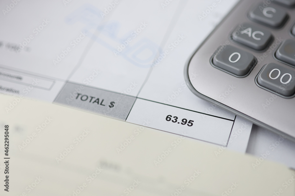 Paid goods and calculator on counting paper for time-based payments in Business finance office Paid goods and calculator on counting paper for time-based payments in Business finance office