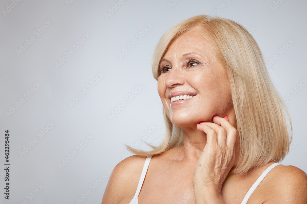 Portrait of beautiful blond senior woman posing and looking away. Beauty photography Portrait of beautiful blond senior woman posing and looking away. Beauty photography