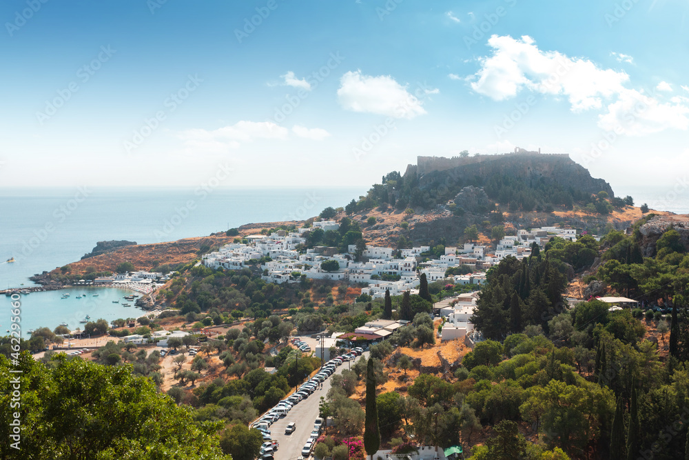 Panoramic view of the old town of Lindos in Greece with the acropolis on top of the hill. Panoramic view of the old town of Lindos in Greece with the acropolis on top of the hill.