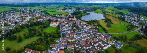 Aerial around the city and palace Kißlegg in Germany on a cloudy day in summer