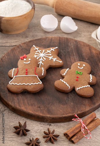 Fototapeta Naklejka Na Ścianę i Meble -  Traditional christmas gingerbread cookies over a wooden table with ingredients